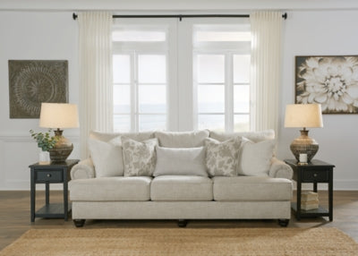 Ashley Furniture Asanti Sofa with plush fabric and modern design, featuring wide armrests and cushioned seating.