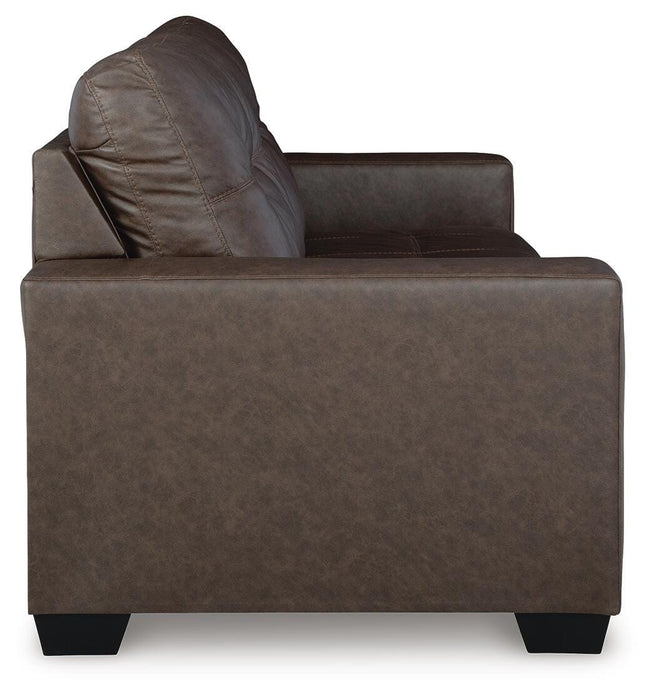 Ashley Furniture Barlin Mills sofa with beige fabric, plush cushions, and rolled armrests in a modern living room setting.