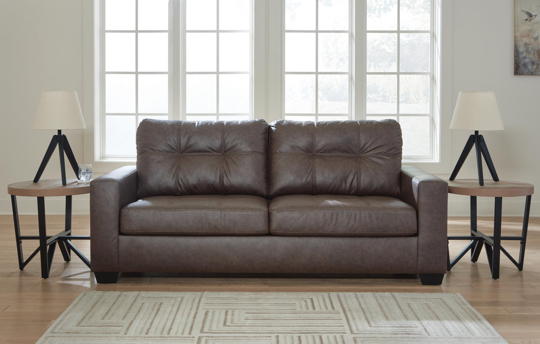 Ashley Furniture Barlin Mills Sofa with plush beige upholstery and rolled armrests, shown from the front.