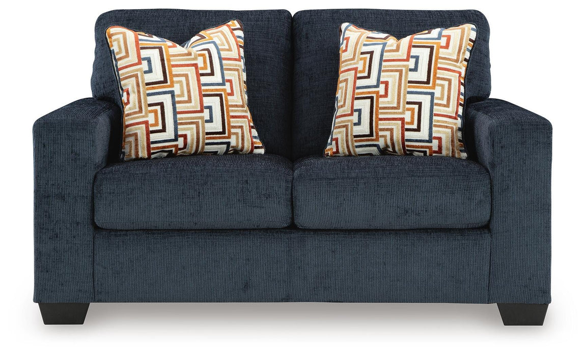 Ashley Furniture Aviemore loveseat with plush cushions and wooden legs, shown from a head-on angle.