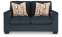 Ashley Furniture Aviemore loveseat with plush cushions and wooden legs, shown from a head-on angle.