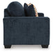 Ashley Furniture Aviemore loveseat with plush beige upholstery and tapered wooden legs, shown from the side view.