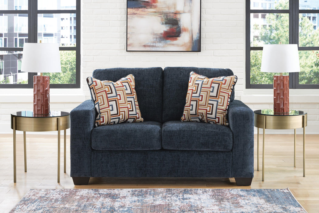 Ashley Furniture Aviemore loveseat with plush fabric and cushioned armrests, perfect for cozy living room seating.