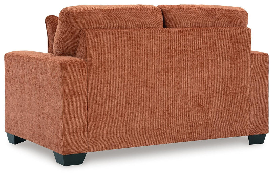 Ashley Furniture Aviemore loveseat with plush fabric and cushioned backrest, shown in a cozy living room setting.