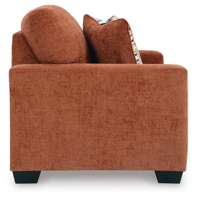 Ashley Furniture Aviemore loveseat with plush fabric and cushioned armrests, shown in a cozy, stylish living room setting.