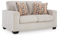 Ashley Furniture Aviemore loveseat with plush fabric and overstuffed cushions, shown from an angled view.