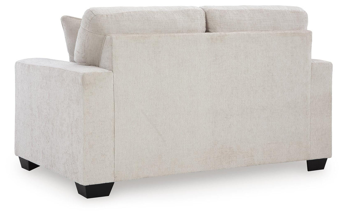 Ashley Furniture Aviemore loveseat with plush fabric and cushioned back, shown from the rear view.