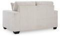 Ashley Furniture Aviemore loveseat with plush fabric and cushioned back, shown from the rear view.