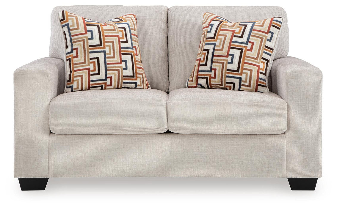 Ashley Furniture Aviemore loveseat with plush fabric and cushioned armrests, shown from head-on perspective.