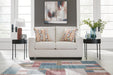 Ashley Furniture Aviemore loveseat with plush fabric and cushioned arms, perfect for cozy living room seating.