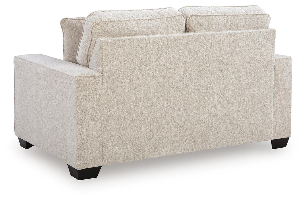 Ashley Furniture Larimer living room set with plush sofas and coordinating chairs, shown in a cozy, modern living space.