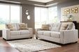 Ashley Furniture Larimer living room set with beige fabric sofa and matching armchair in a modern design.