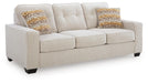 Ashley Furniture Larimer living room set featuring a sofa and loveseat with plush cushions and neutral upholstery, angled view.