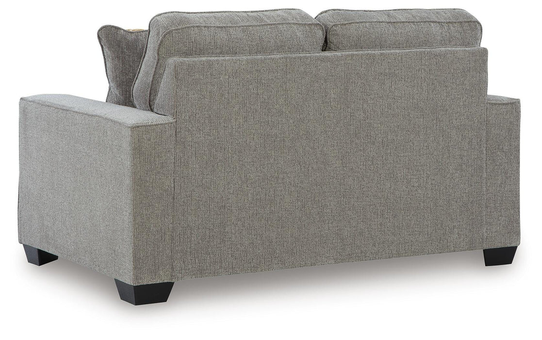 Ashley Furniture Larimer living room set with sofa and loveseat in a modern fabric, shown from the back in a stylish home setting.
