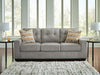 Ashley Furniture Larimer living room set with beige fabric sofa and matching armchair in a modern living space