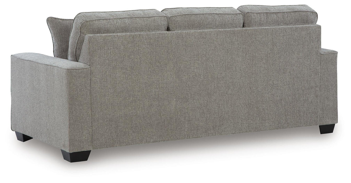 Ashley Furniture Larimer living room set featuring a sofa and loveseat with plush cushions and neutral upholstery, viewed from the back.