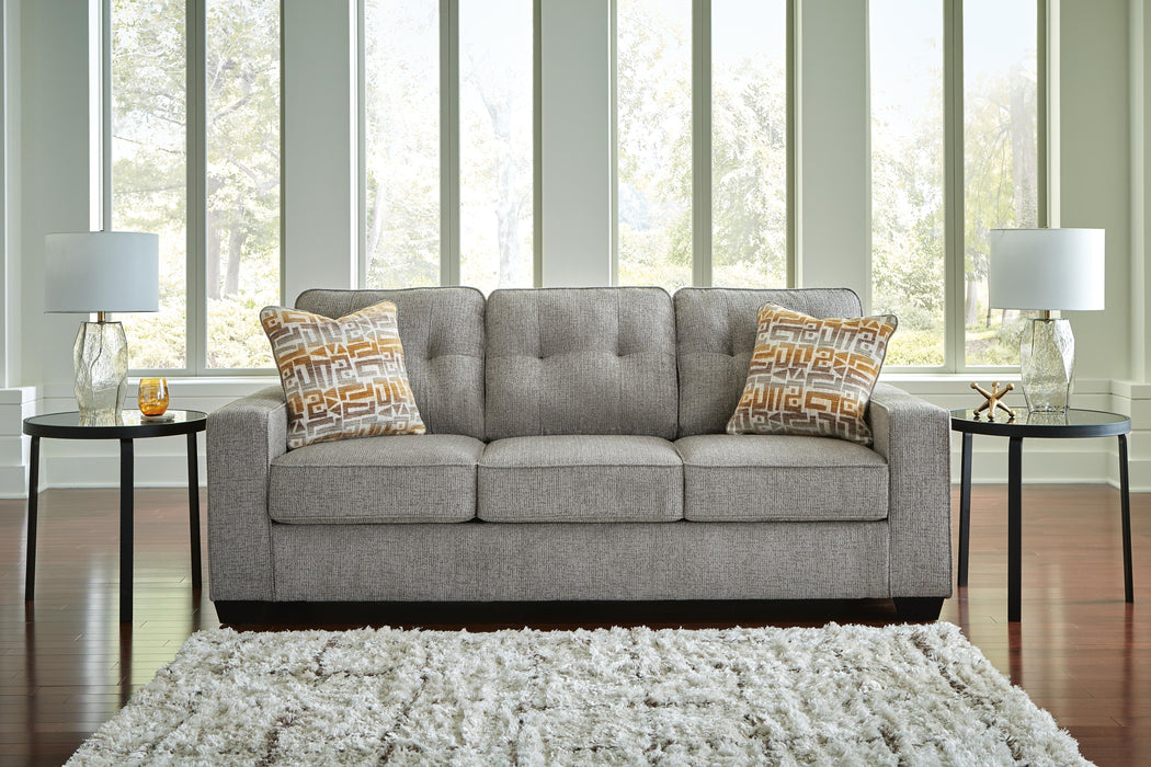 Ashley Furniture Larimer living room set with sofa, loveseat, and armchair, featuring neutral upholstery and wooden legs.