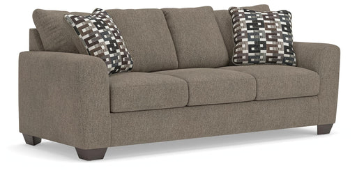 Ashley Furniture Triston-Peaks sofa sleeper with plush fabric, showing the angled view of the versatile sofa bed in a cozy living room setting.