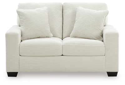 Greenbriar loveseat by Ashley Furniture featuring plush green upholstery and comfortable seating in a cozy living room setting.