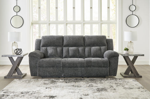 Ashley Furniture Frohn Reclining Sofa, closed position, dark gray fabric with plush cushions and reclining features.
