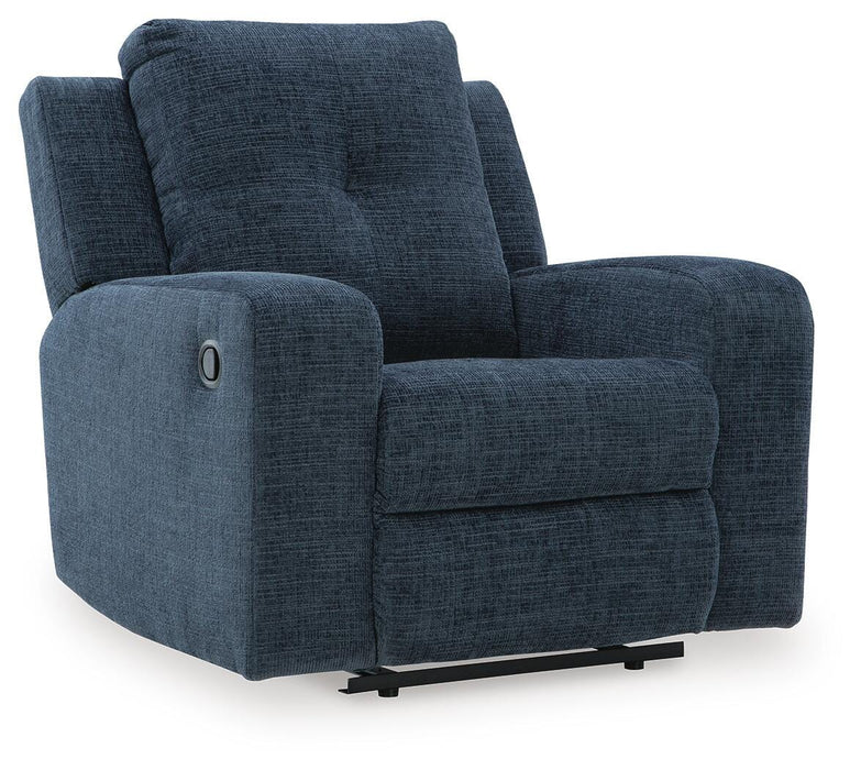 Ashley Furniture Danum Recliner in dark brown fabric, shown from a side angle with plush cushioning and armrests.