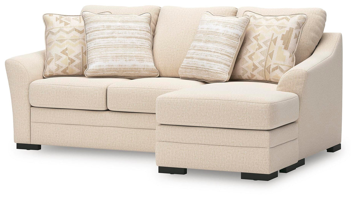 Ashley Furniture Lango Sofa Chaise in beige fabric, angled view showing plush cushions and modern design.