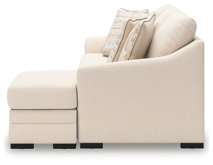 Ashley Furniture Lango Sofa Chaise in beige fabric with clean lines and plush cushions, shown from a side angle.