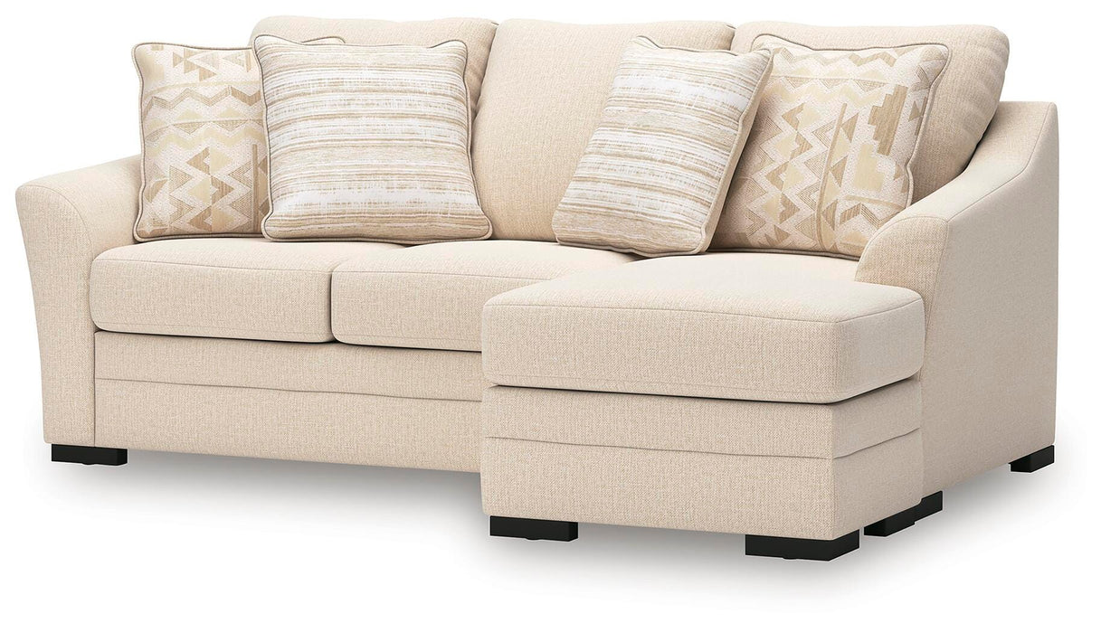 Ashley Furniture Lango Sofa Chaise Sleeper in neutral fabric, featuring a modern design with a spacious sleeping and seating area.