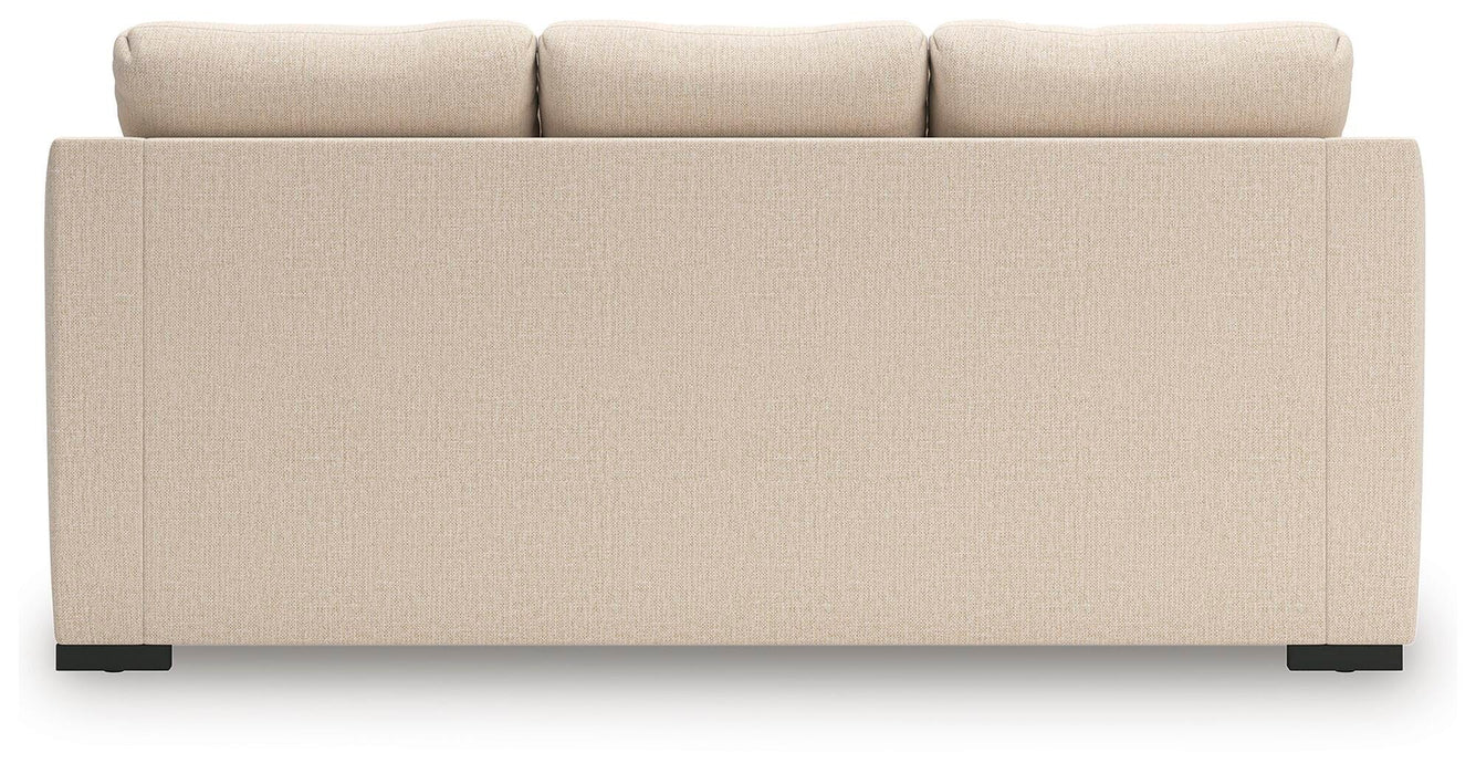 Ashley Furniture Lango sofa chaise sleeper with plush back cushions and fabric upholstery, shown from the back.
