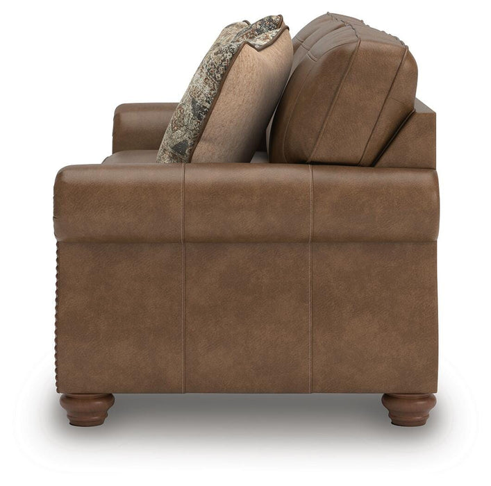 Ashley Furniture Chasemore sofa with plush cushions and modern design, shown from the side in a cozy living room setting.