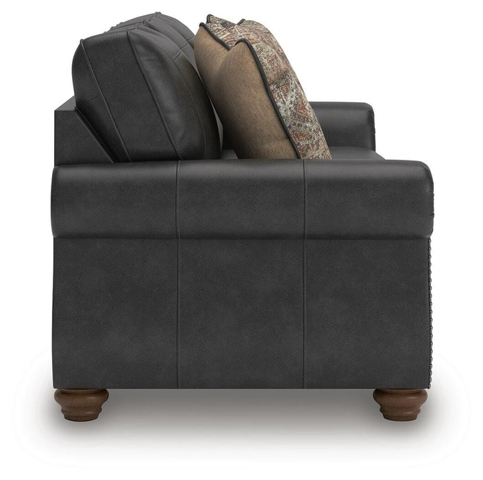 Ashley Furniture Chasemore sofa with plush cushions and neutral fabric, shown from a side angle in a modern living room setting.