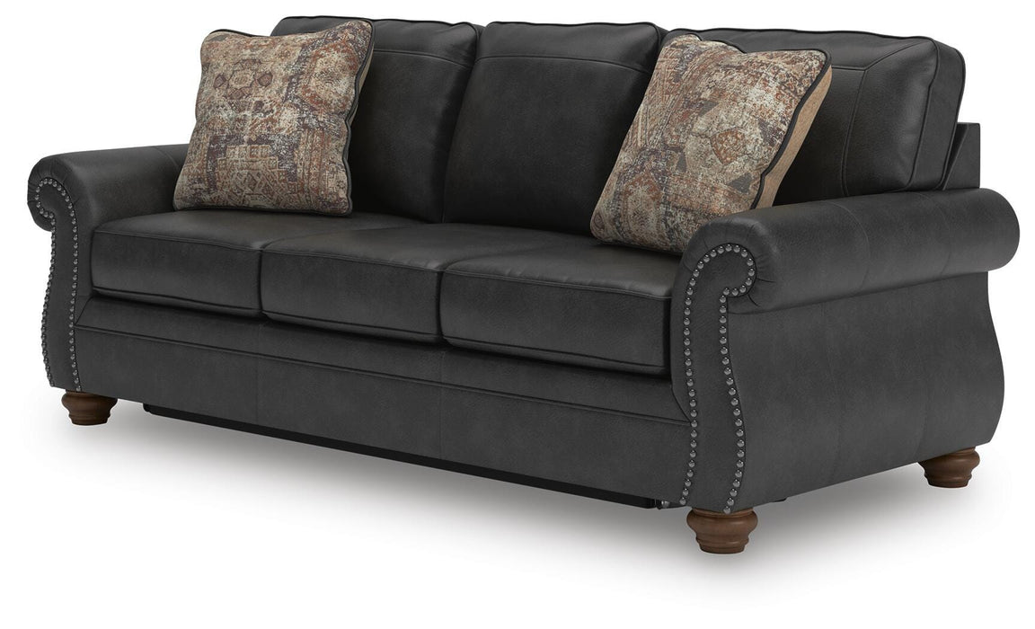 Ashley Furniture Chasemore sleeper sofa with beige fabric and plush cushions, shown from an angled view.