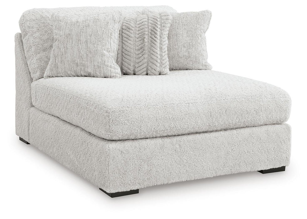 Ashley Furniture Cuddle Plush sectional with chaise, featuring soft upholstery and plush cushions, shown from an angled side view.