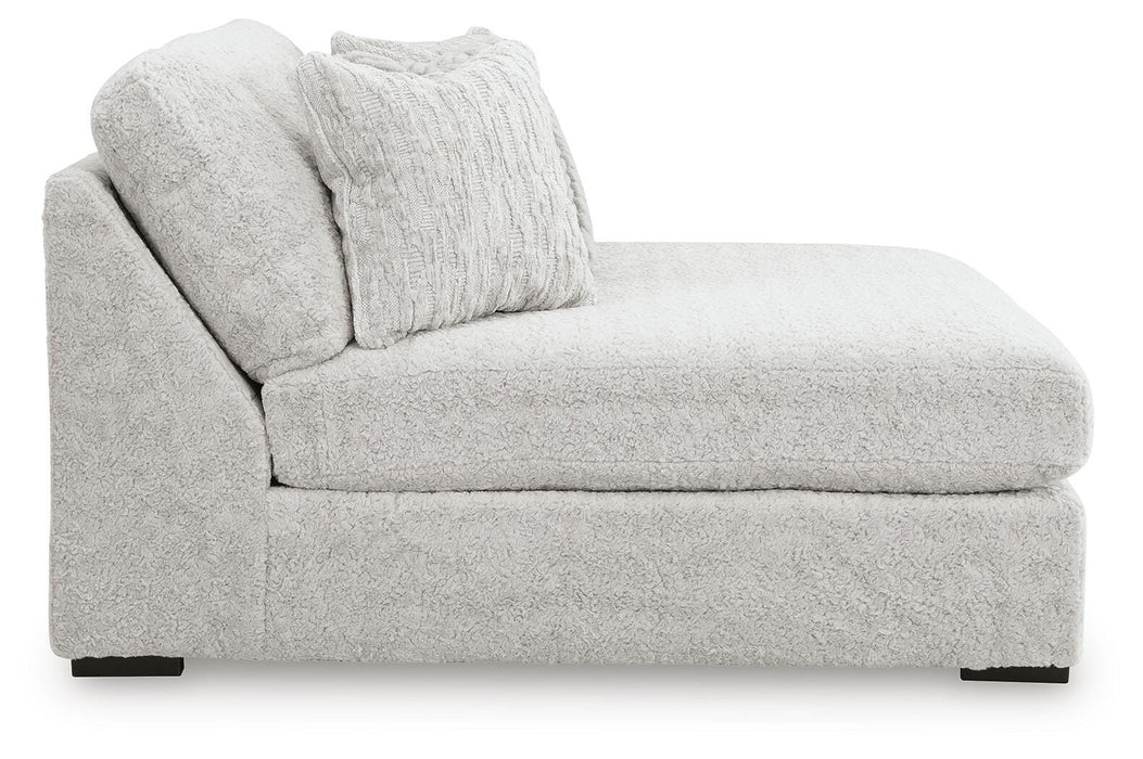 Ashley Furniture Cuddle Plush sectional with chaise, soft fabric upholstery and modern design, shown from side angle.