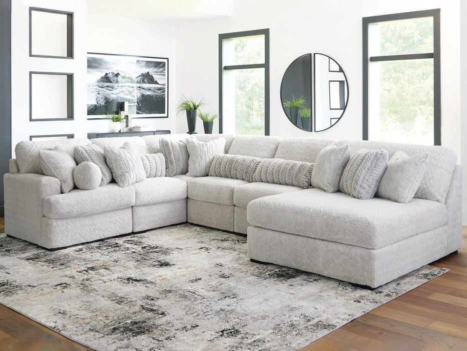 Ashley Furniture Cuddle Plush sectional with chaise, soft fabric, and modern design, shown in a cozy living room setting.