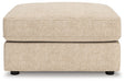 Ashley Furniture Seyler oversized accent ottoman with plush fabric and sturdy wooden legs, shown from a head-on angle.