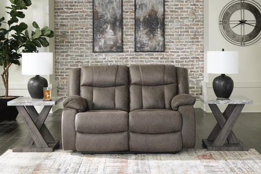 Ashley Furniture First Base reclining loveseat with plush cushions and a neutral fabric finish, shown in a closed position.