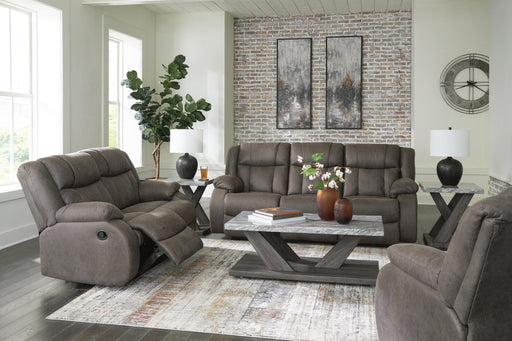 Ashley Furniture First Base living room set with sofa and armchair in a modern design, featuring neutral upholstery and wooden legs.