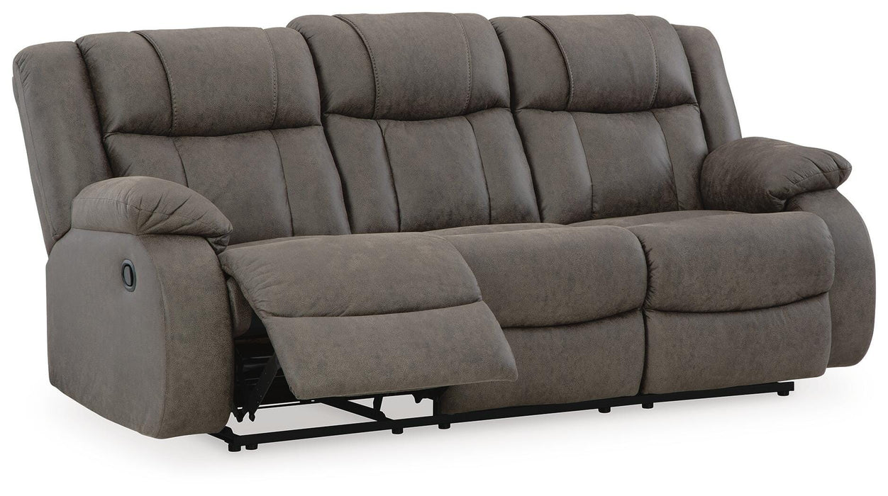 Ashley Furniture First Base reclining sofa, open view showing plush cushions and reclining mechanism from an angled perspective.