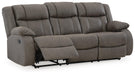 Ashley Furniture First Base reclining sofa, open view showing plush cushions and reclining mechanism from an angled perspective.