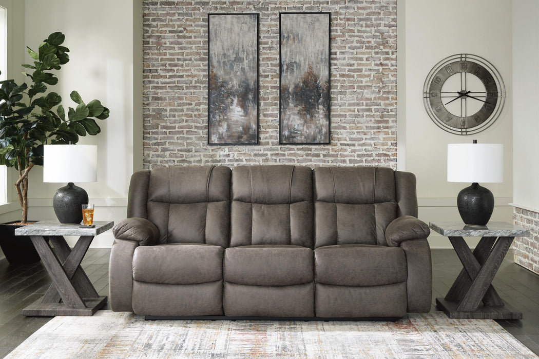 First Base reclining sofa by Ashley Furniture featuring plush cushions and a modern design, shown in a closed reclining position.