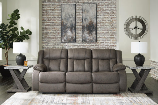 First Base reclining sofa by Ashley Furniture featuring plush cushions and a modern design, shown in a closed reclining position.