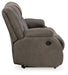 Ashley Furniture First Base reclining sofa with plush cushions and a neutral fabric, shown from the side in a modern living room setting.