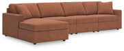 Ashley Furniture Modmax sectional with chaise, featuring plush cushions and modern design in a fabric upholstery setting.