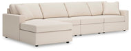Ashley Furniture Modmax sectional with chaise, showcasing a modern design with plush cushions and neutral fabric upholstery.