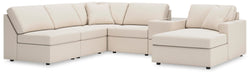 Ashley Furniture Modmax sectional with chaise in neutral fabric, showing the modern L-shaped sofa with plush cushions and chaise lounge.