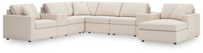 Ashley Furniture Modmax sectional with chaise, featuring plush cushions and modern design in a cozy living room setting.