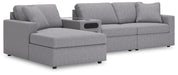 Ashley Furniture Modmax sectional with chaise, featuring modern design and plush upholstery in a spacious living room setting.
