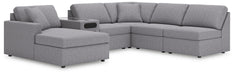 Ashley Furniture Modmax sectional with chaise, featuring plush upholstery and modern design in a stylish living room setting.