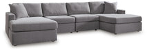 Ashley Furniture Modmax sectional with chaise, featuring modern design, neutral fabric, and plush cushions in a stylish living room setting.